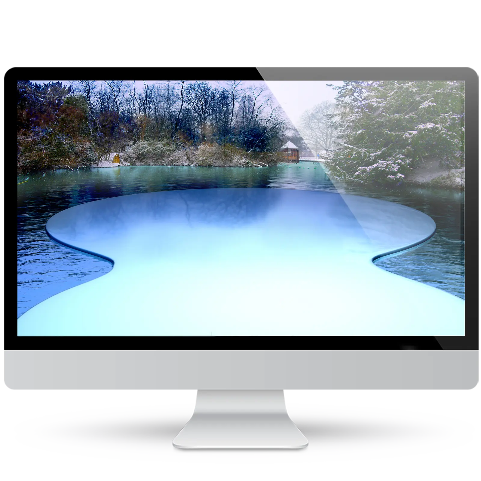 Desktop monitor showing a winter wallpaper of a snowy park lake with bare trees and a small gazebo, above a glowing icy-blue curved stage.