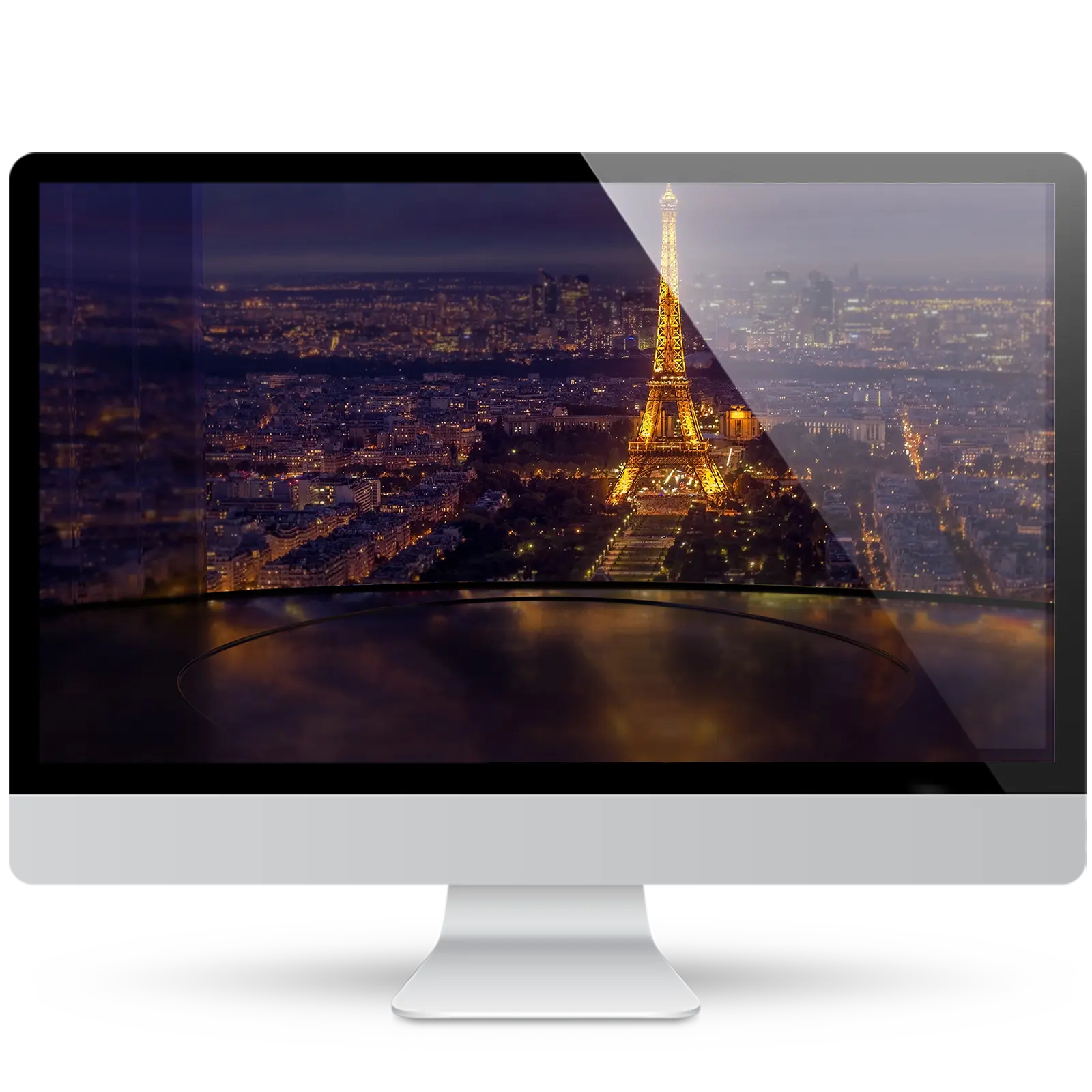 Desktop monitor showing a wallpaper of the illuminated Eiffel Tower and the Paris skyline at night, above a glossy curved stage reflecting the city lights.