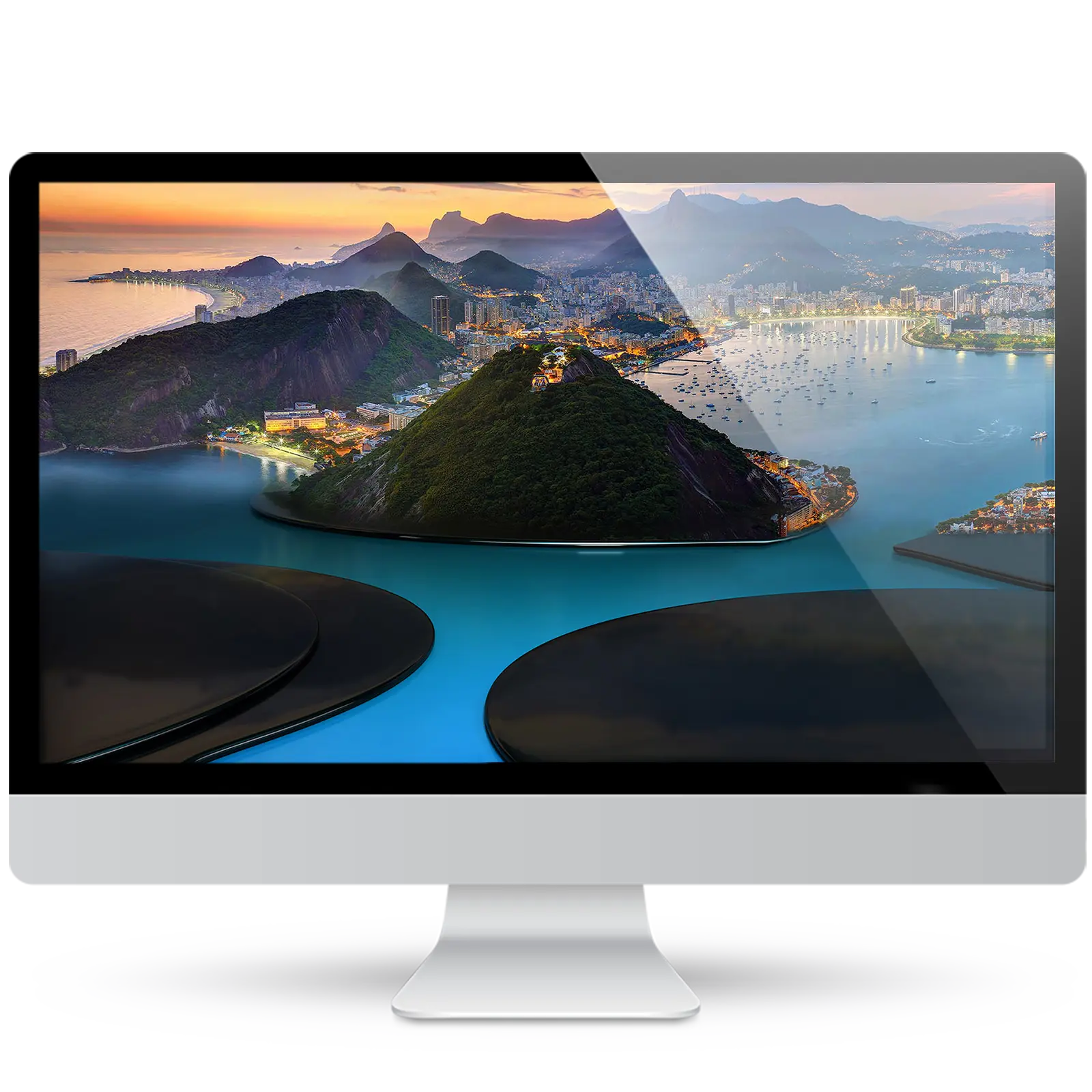 Desktop monitor showing a wallpaper of Rio de Janeiro at dusk: green hills, city lights, Copacabana Beach and Botafogo Bay, above glossy curved platforms.